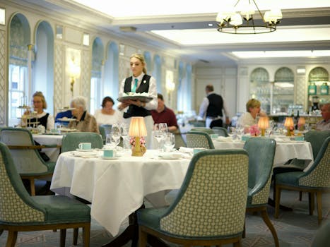 Upscale restaurant setting with a waitress serving guests, creating a luxurious dining experience.