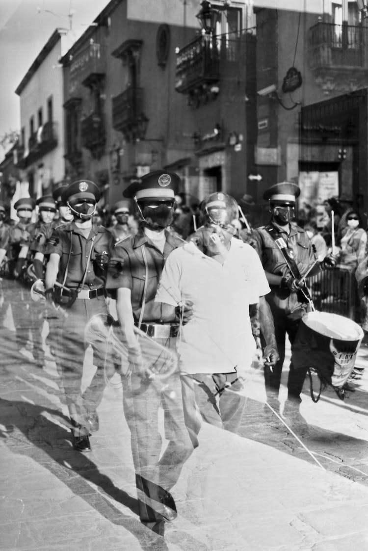 Police Force Marching Along The Street