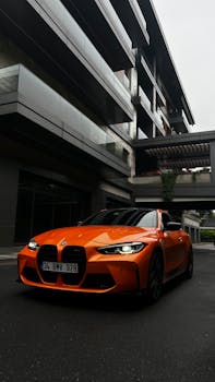 Vibrant orange sports car parked in a contemporary urban area in Turkey.