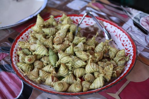 Close-up of traditional Malaysian ketupat palas served on a decorative tray. Perfect for food photography.