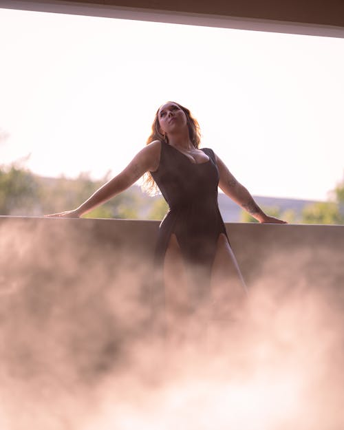 Smoke over Woman in Black Dress