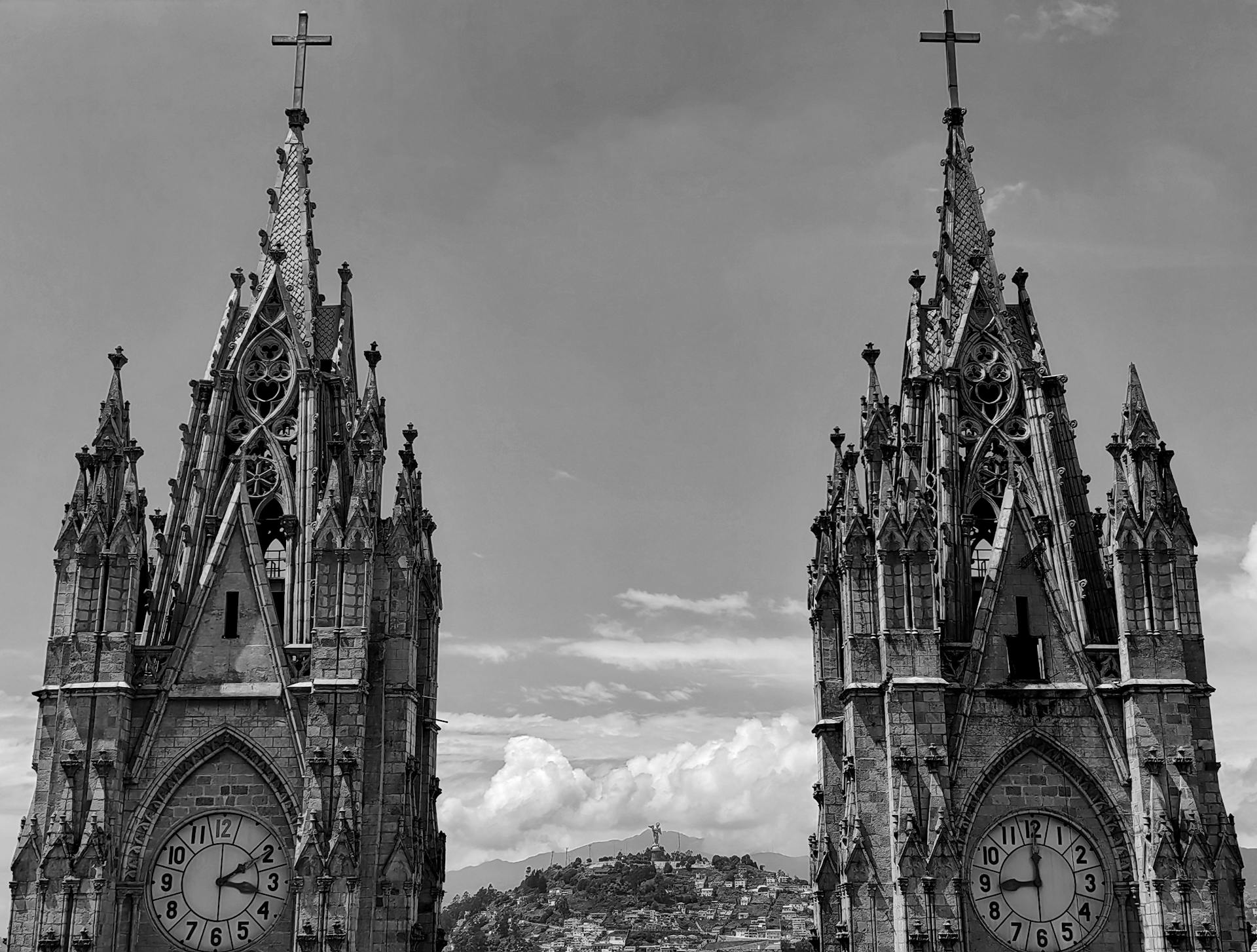 Gothic architecture of Basilica del Voto Nacional with Quito cityscape in the background.