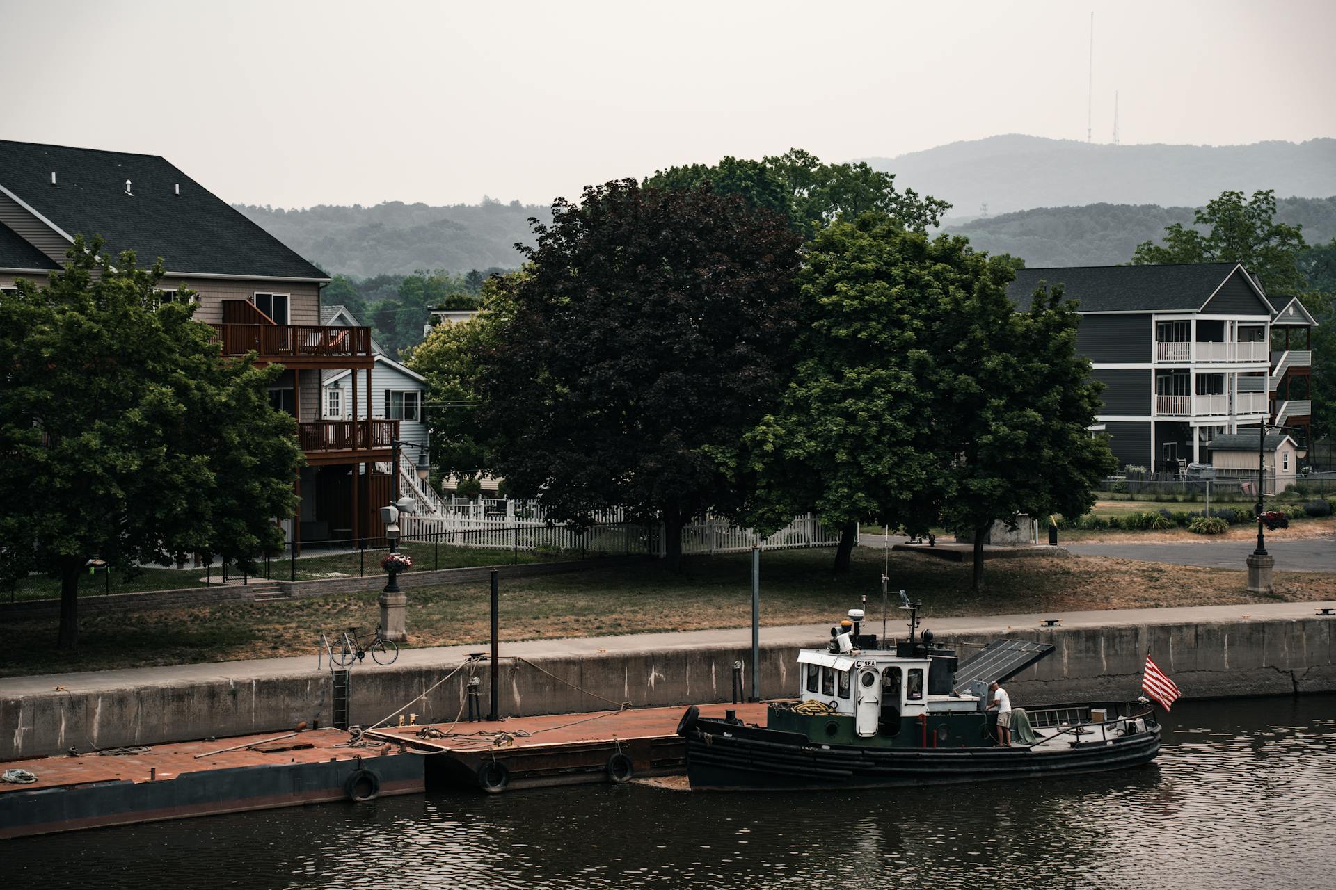 A Tugboat in the Canal in a Town