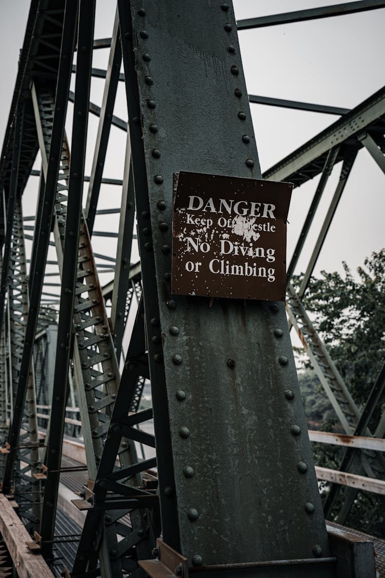 Close-up Of A Warning Sign Attached To A Steel Bridge Construction 