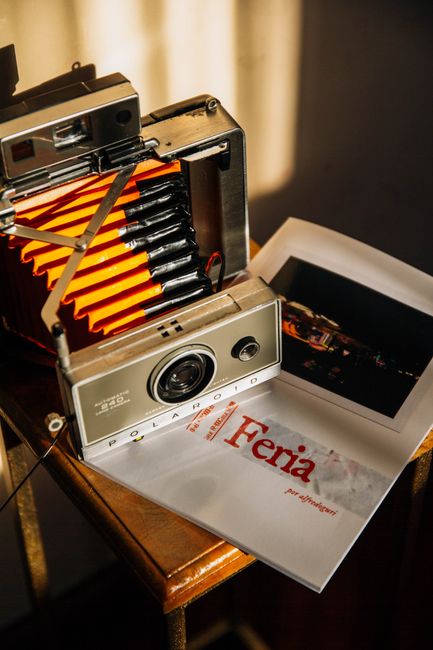 Classic Polaroid camera with a printed photo, capturing a nostalgic feel in warm light.