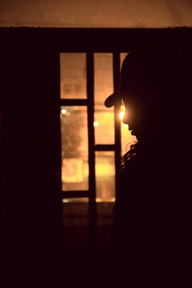 Silhouette Of A Woman In A Dark Room 