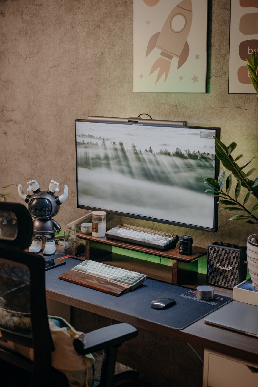 Stylish home office setup with computer, keyboard, and tech gadgets on a desk.. stylish, home, office