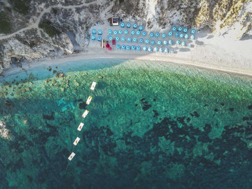 Top View of Clear Turquoise Water and Umbrellas on the Beach 