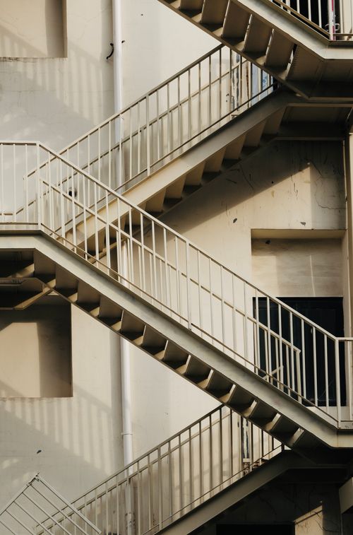 Free Geometric view of an outdoor stairway on an urban building facade. Stock Photo