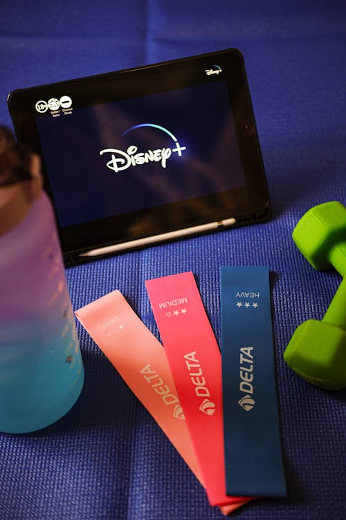 Disney fitness wristbands and a tablet with the disney logo