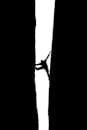 Silhouette of a Man Climbing Up a Narrow Ravine