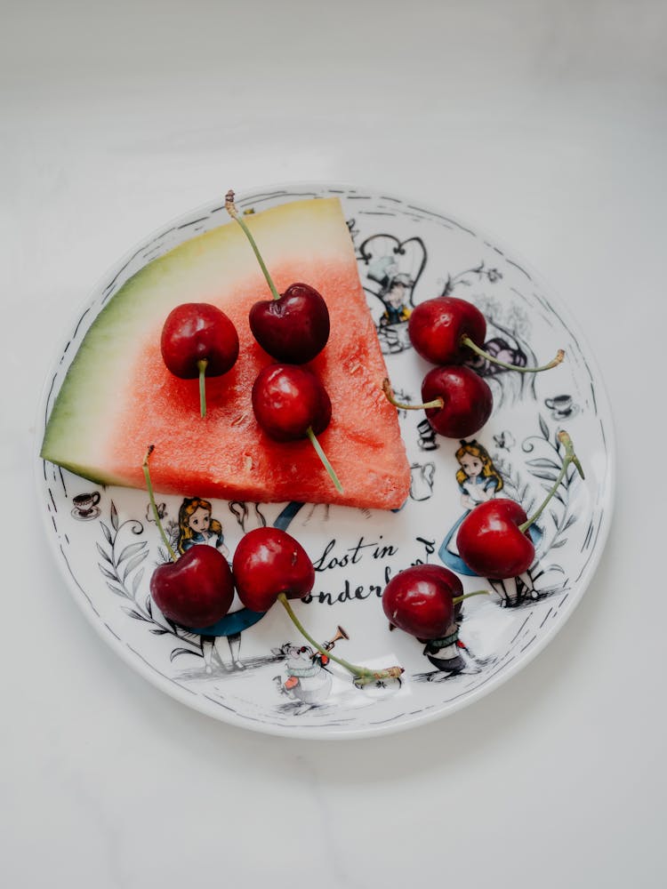 Cherries And A Watermelon Slice On A Plate