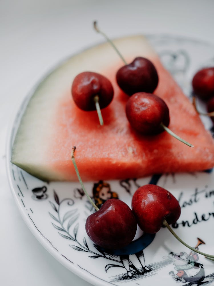 Cherries And A Watermelon Slice On A Plate