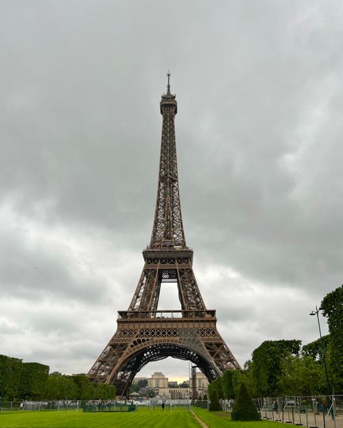 Free Iconic Eiffel Tower set against a dramatic cloudy sky, showcasing Paris's architectural marvel. Stock Photo