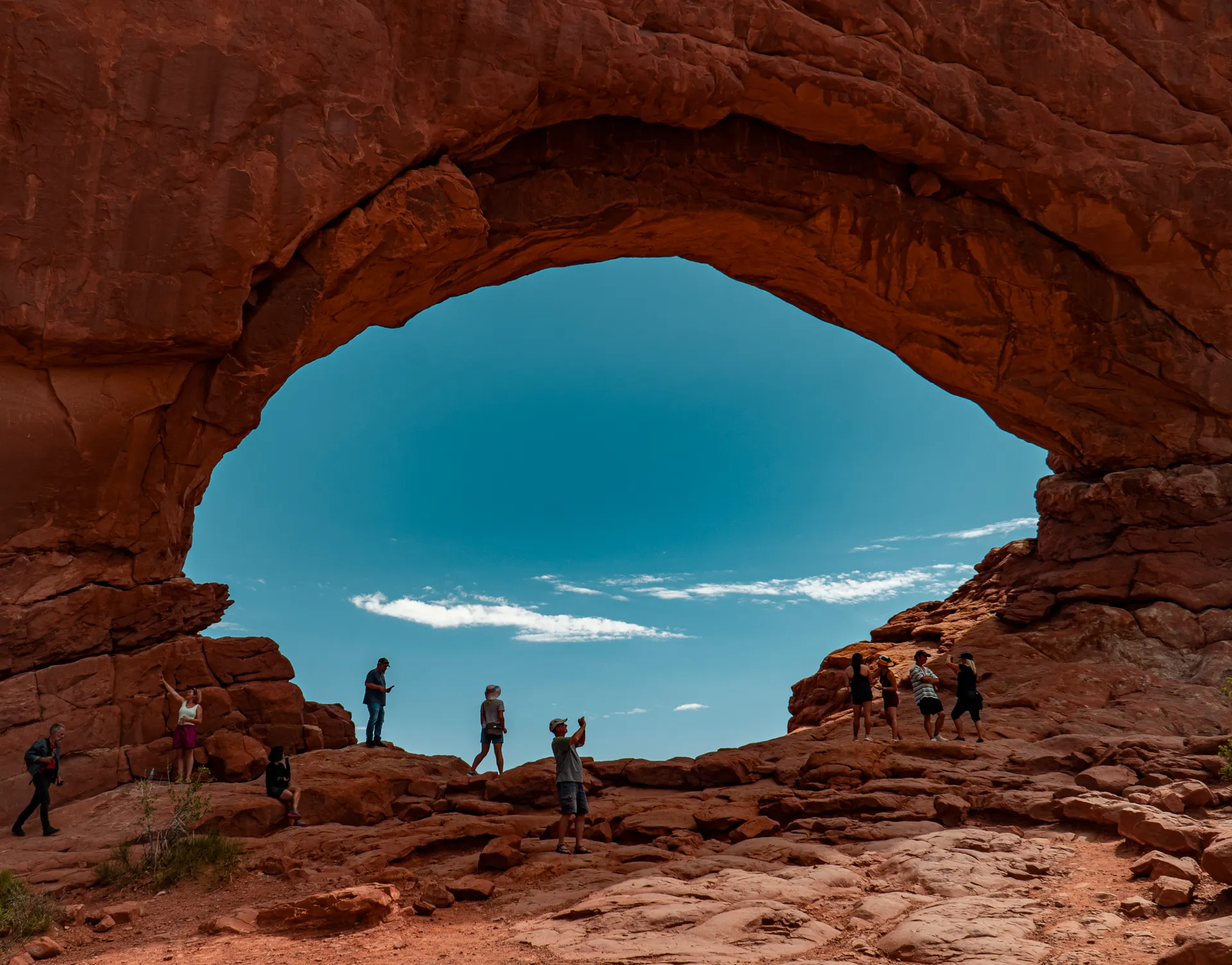 Visitors admire the natural arch formation at Arches National Park, Utah. Visitors admire the natural arch formation at Arches National Park, Utah.