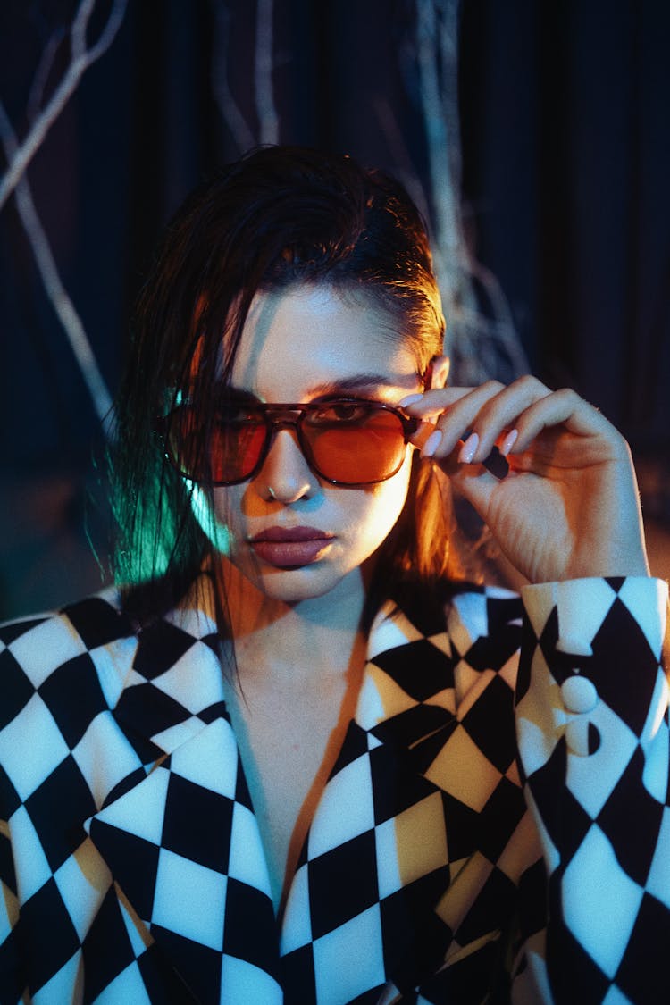 Young Woman In A Checkered Suit And Sunglasses 