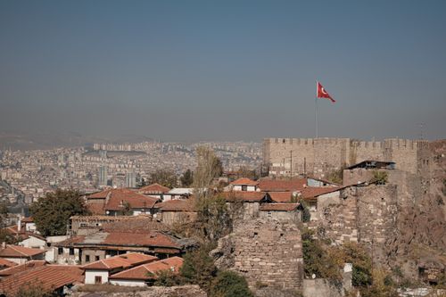 Free Ankara Castle with city skyline under a clear sky, featuring Ottoman architecture and Turkish flag. Stock Photo