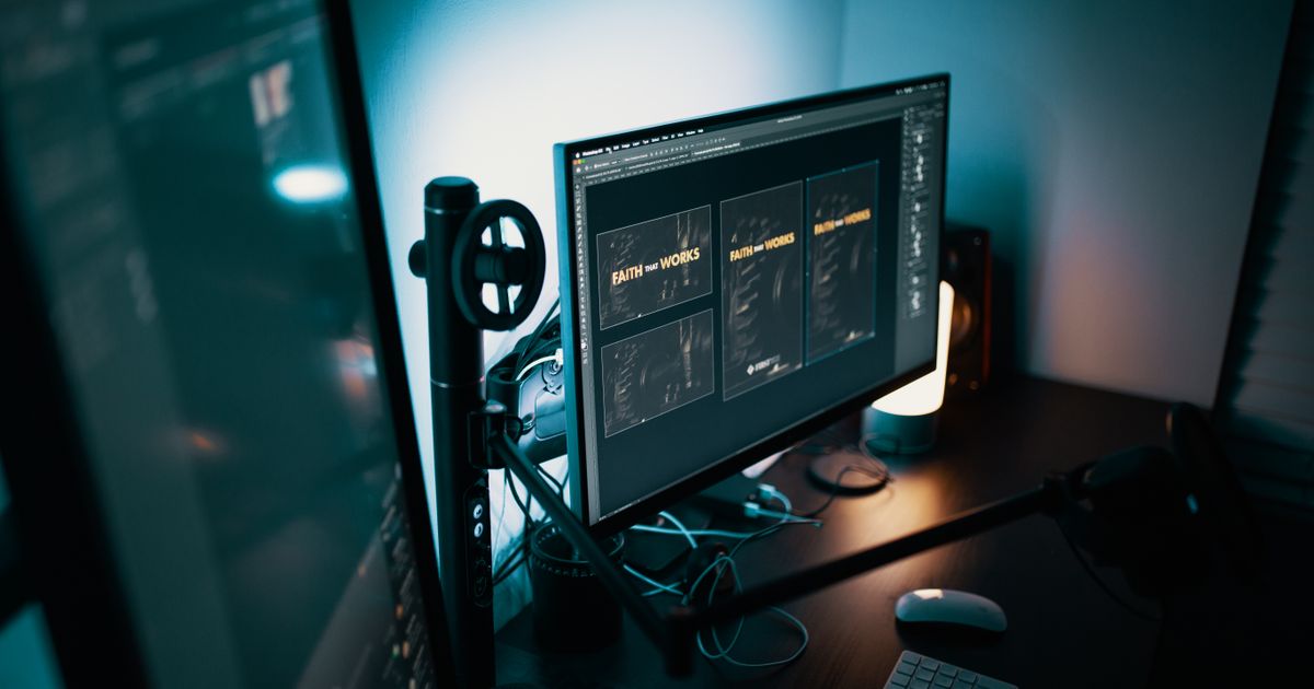 A professional monitor displaying website design templates in a modern workspace, showing the visual design elements that shape a visitor's first impression