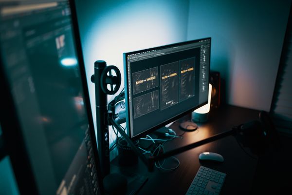 Dimly lit workspace with dual monitors by Josh Sorenson on Pexels