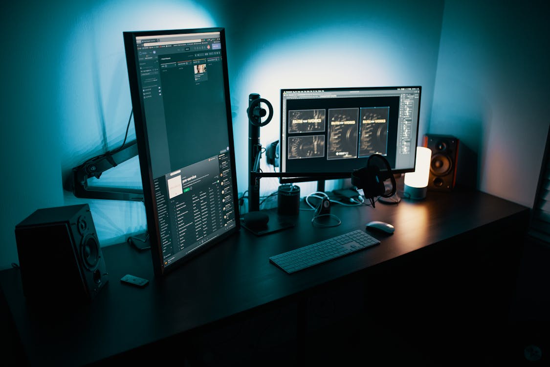 Image of two computer screens on a desk