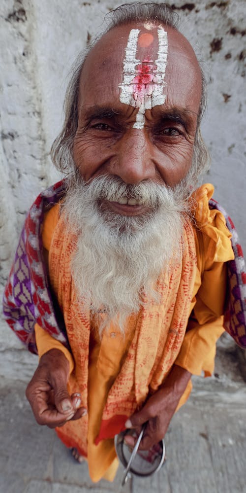 High Angle Shot of an Elderly Man with a Long Gray Beard Wearing a Traditional Religious Gown 