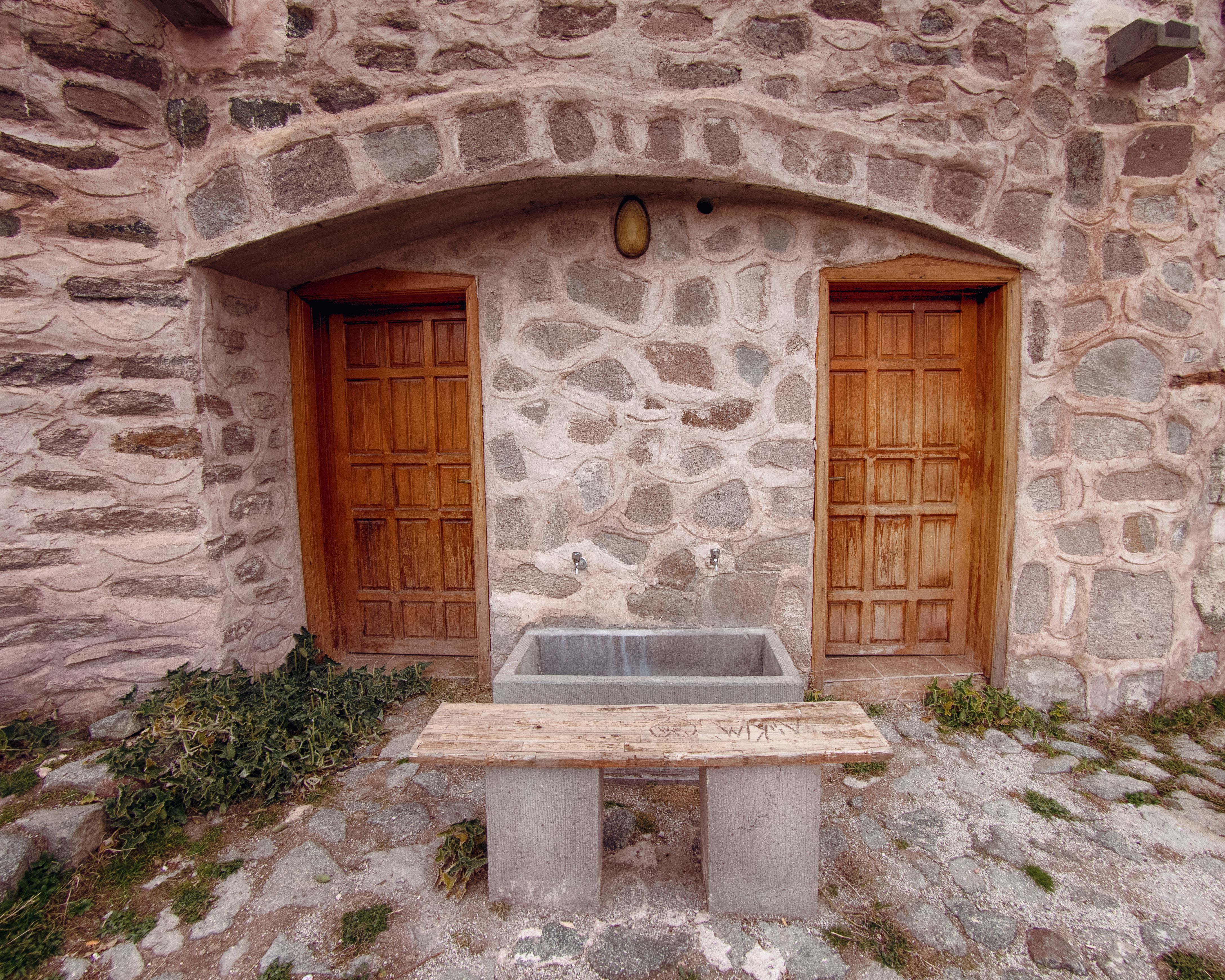 Facade of a Stone Building with Wooden Doors · Free Stock Photo