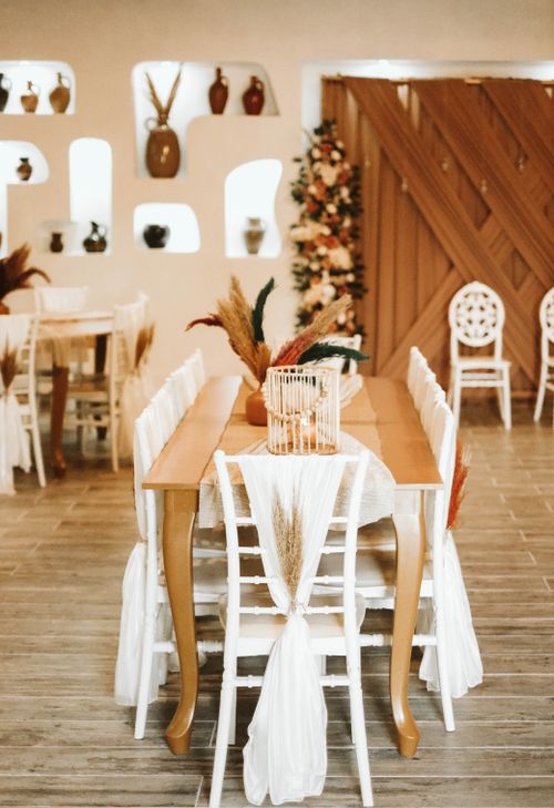 Free Charming boho-style interior showcasing rustic decor and ornamental dry grass in a cozy setting. Stock Photo