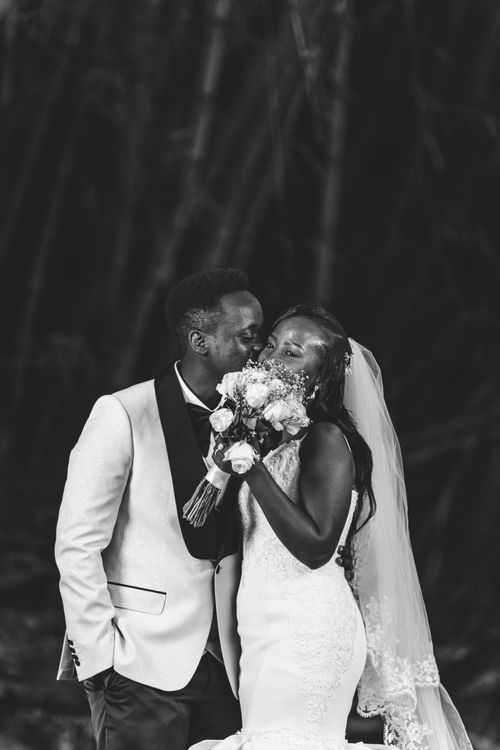 Free Bride and groom kissing in an elegant black and white wedding photo. Stock Photo
