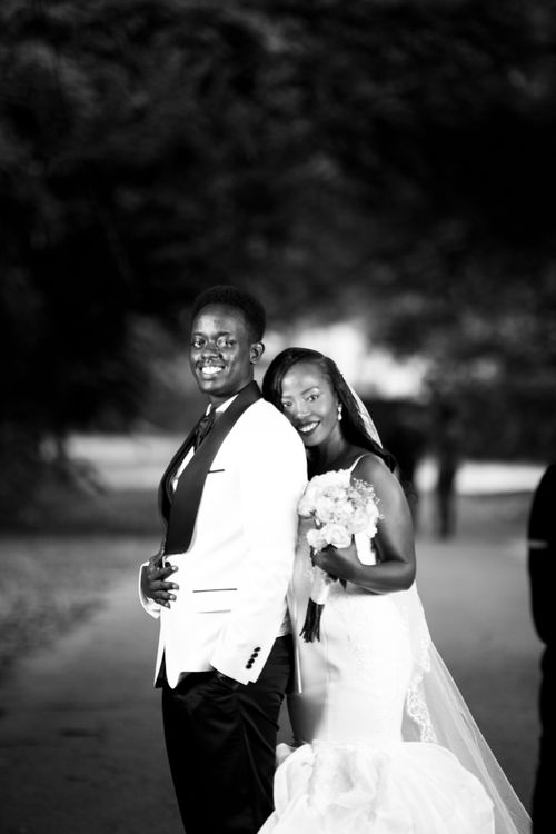 Free Stylish black and white photo of newlyweds embracing, capturing timeless elegance. Stock Photo