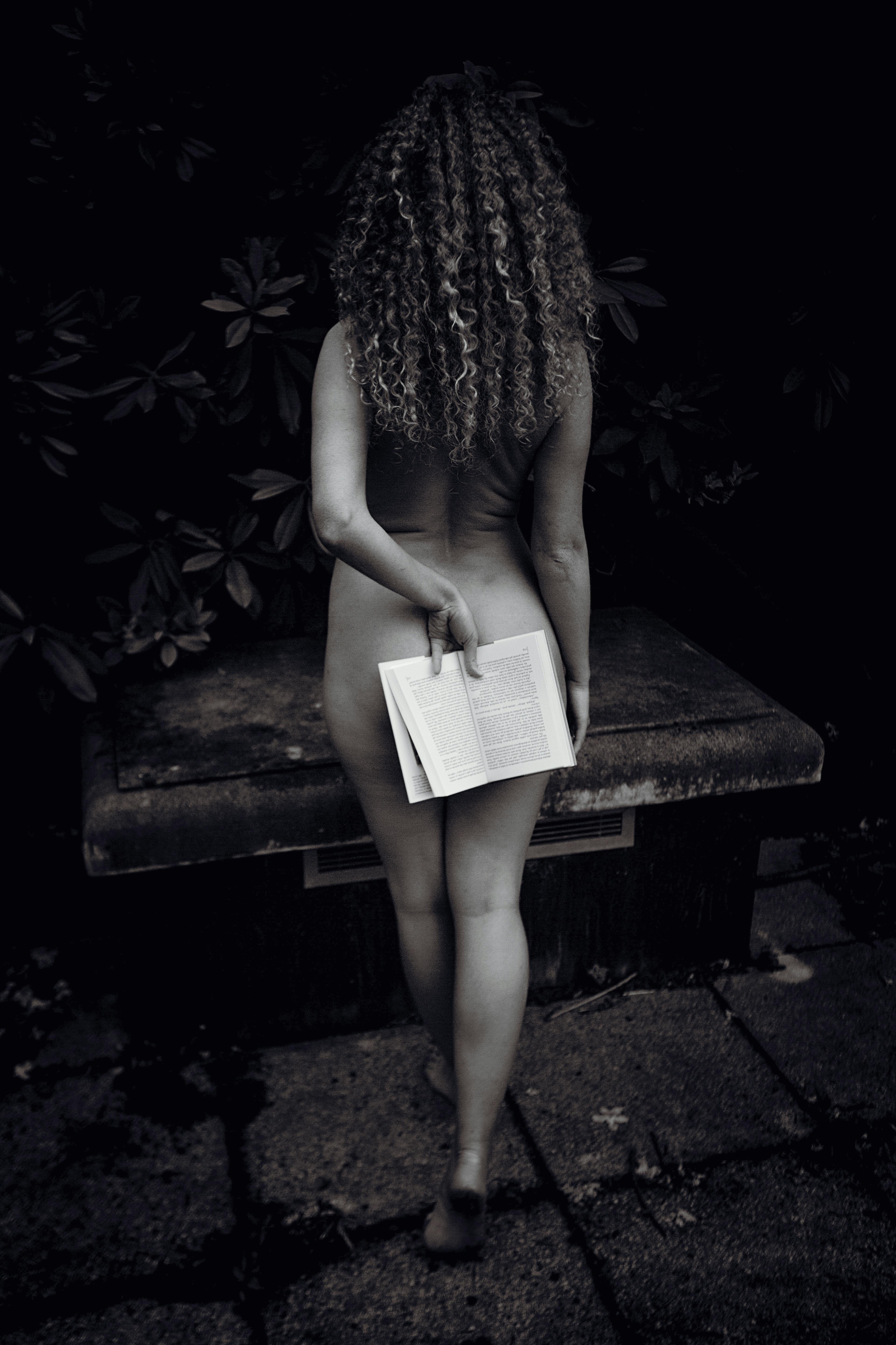 Naked Woman Holding Open Book behind her Back · Free Stock Photo