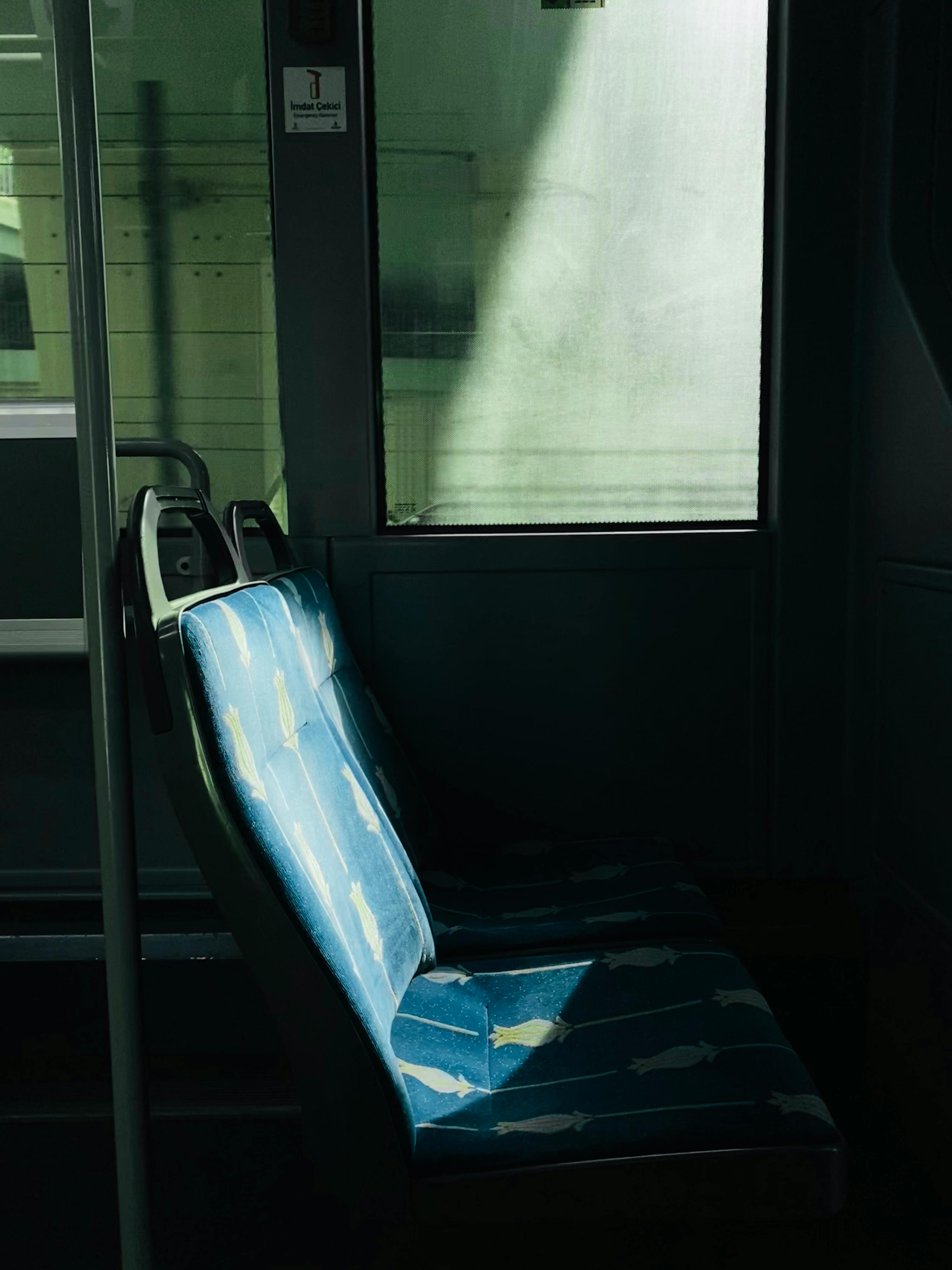 Sunlit empty tram seats in Istanbul capturing urban tranquility and daily transit views.
