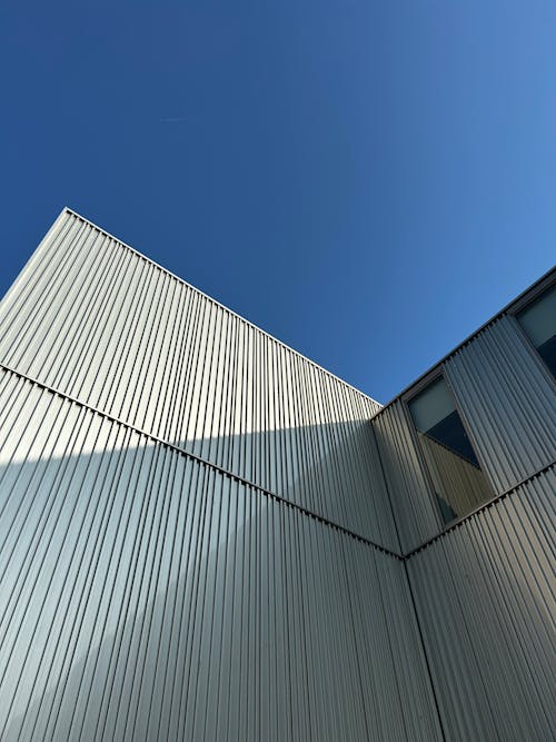 Low Angle Shot of a Modern Building against Blue Sky 