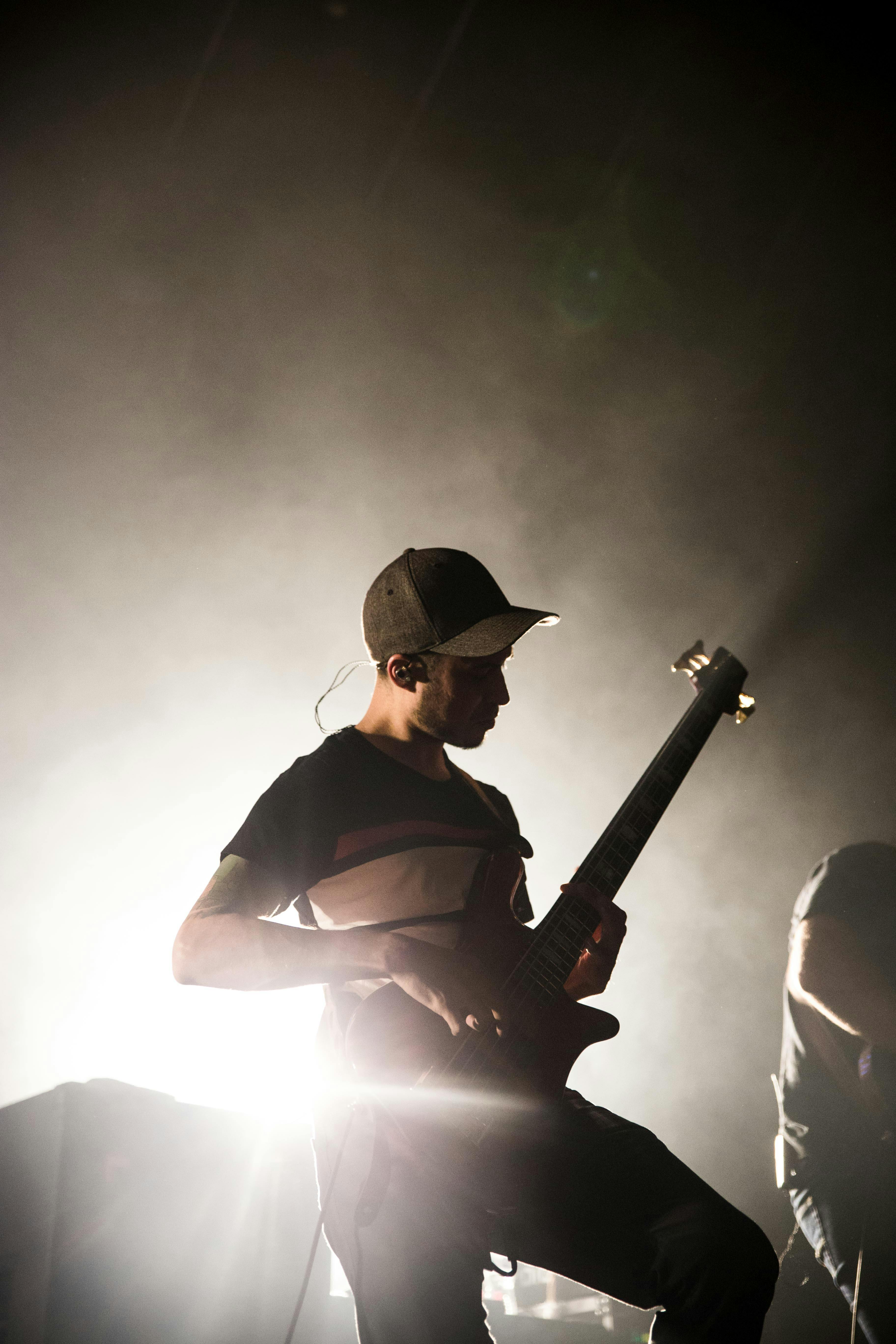 photo of man playing electric guitar