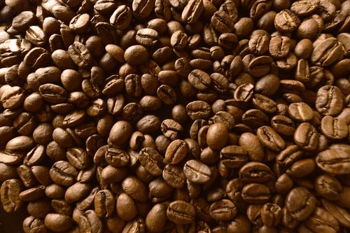 Free A detailed close-up of roasted coffee beans, perfect for background and texture uses. Stock Photo
