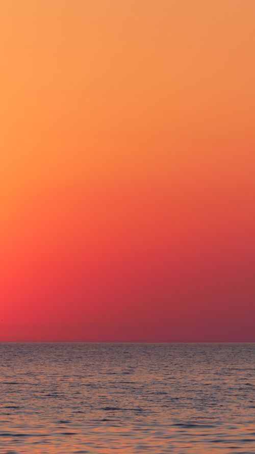 Free Captivating sunset over ocean with vibrant pink and orange hues, creating a dramatic and tranquil seascape. Stock Photo