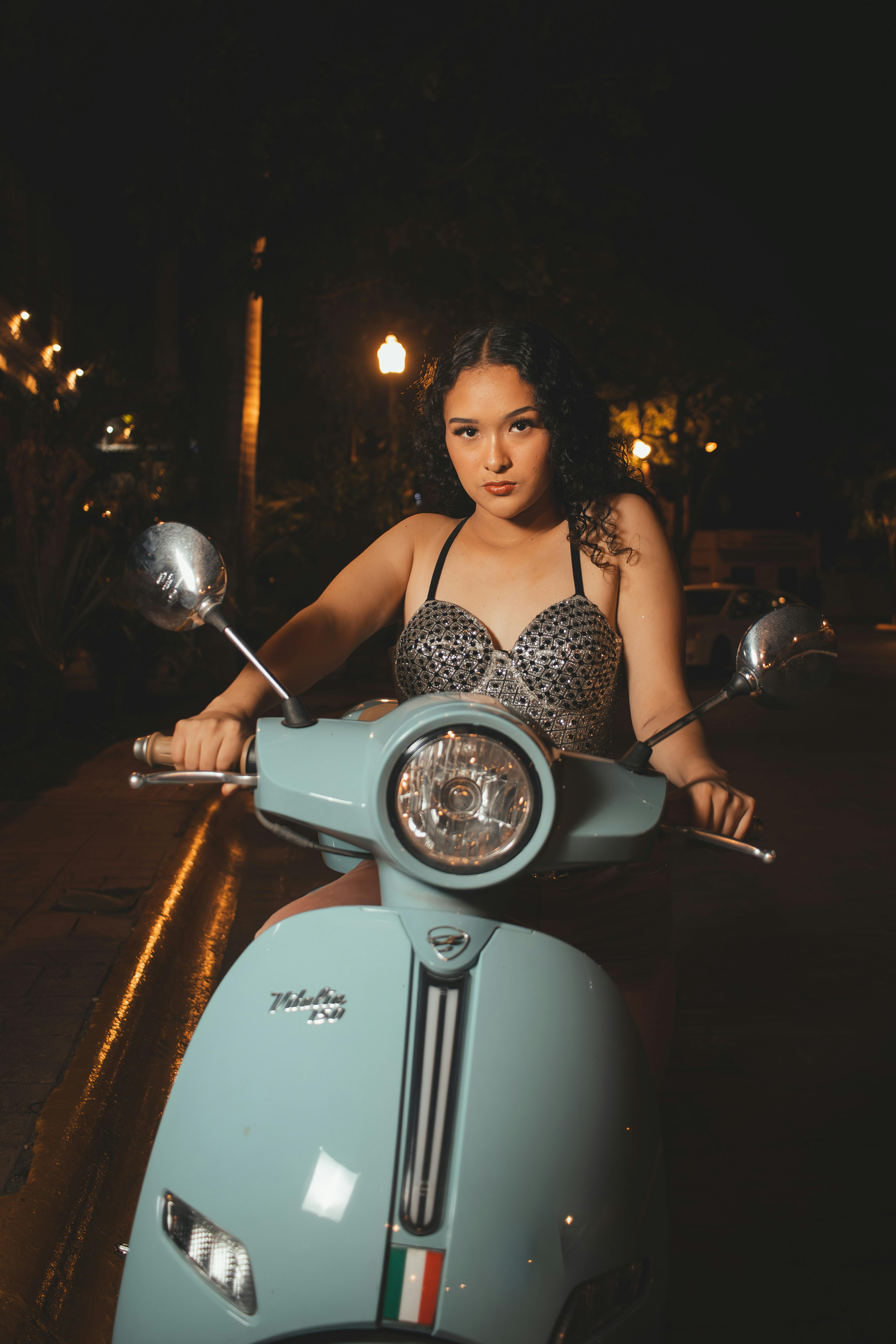 A fashionable young woman with sunglasses posing on her scooter Stock Photo  - Alamy