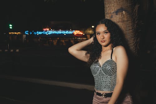 Young Woman in a Trendy Outfit Posing in City at Night 