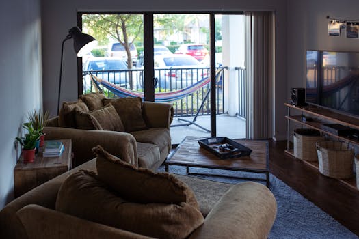 A warm and inviting modern living room with stylish decor and a hammock outside.