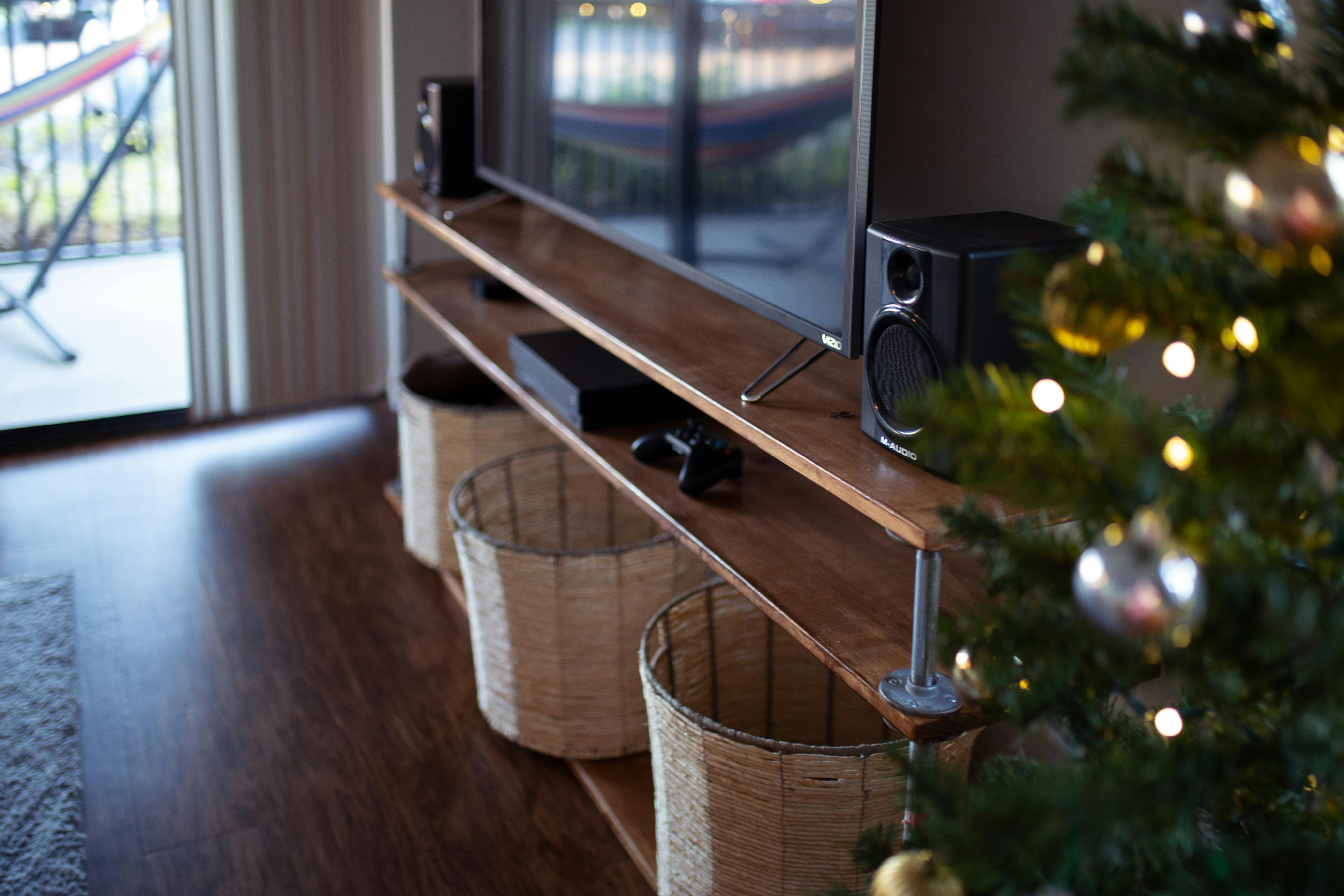 flat screen tv on brown tv stand