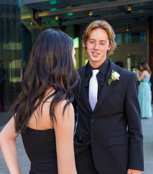 Smiling Man in Suit with Woman in Black Dress