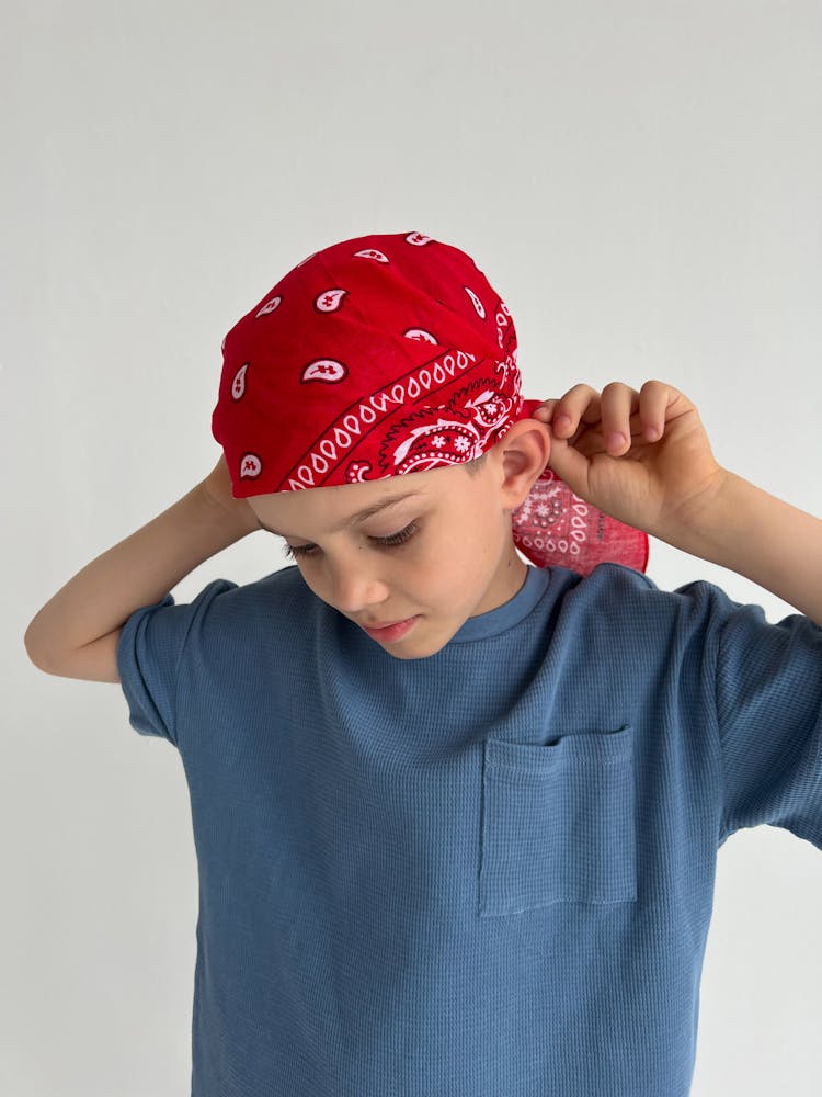 A Child Wearing A Bandana 