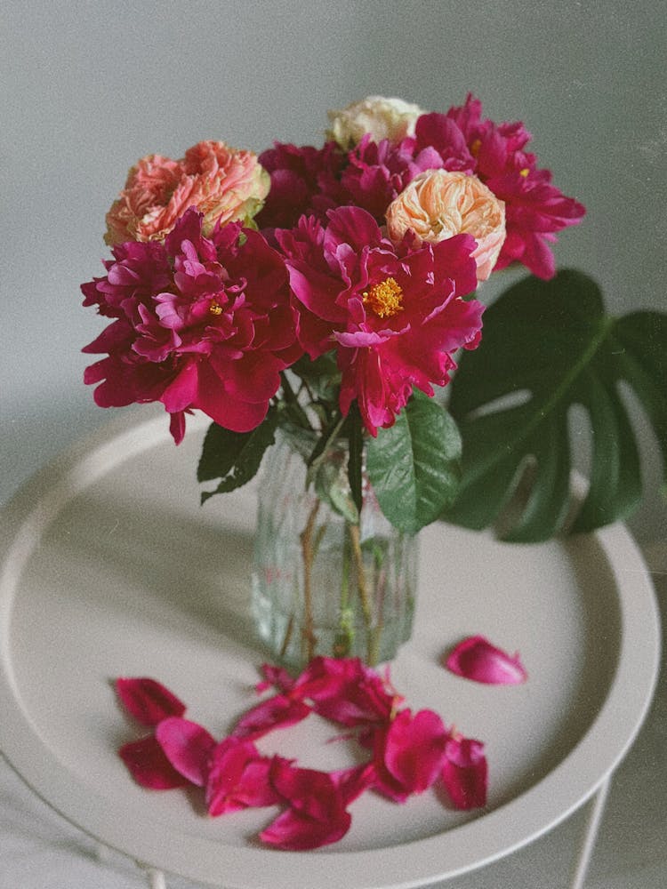 A Bunch Of Pink Peonies In A Glass Vase 