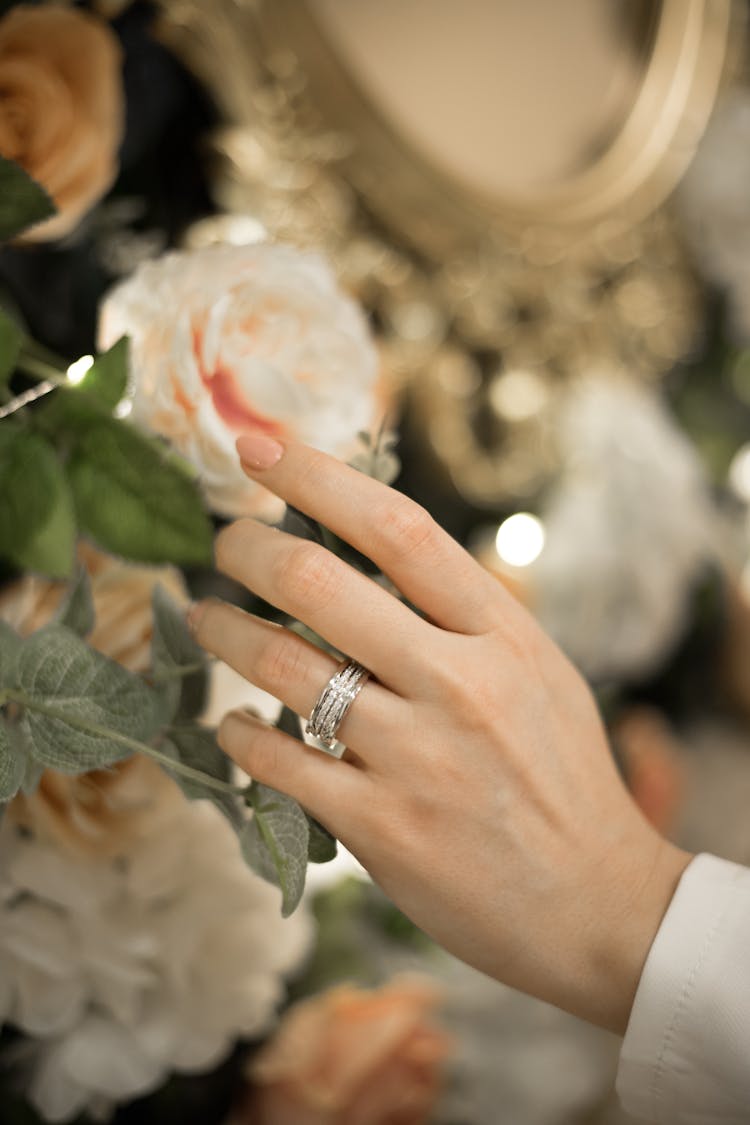 Woman Hand Touching Flower