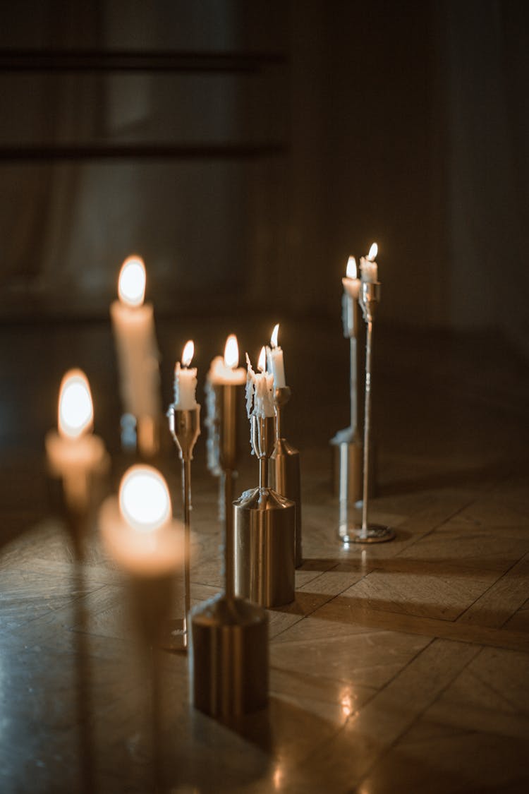 Candlesticks In Silver Candle Holders On The Floor 