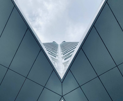 A striking upward view of a modern skyscraper in Frankfurt, showcasing contemporary architecture and geometric design.