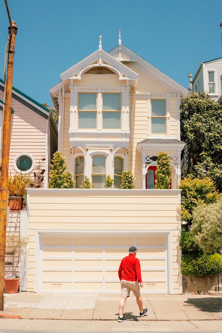 Man Walking Near House Garage Door