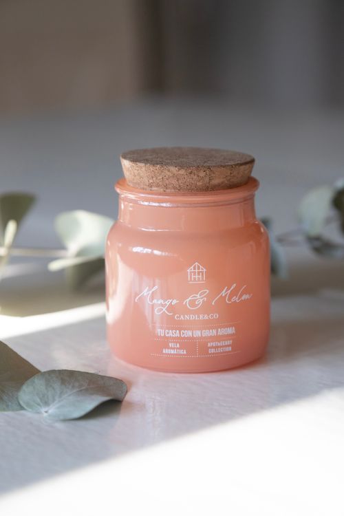 Free Close-up of a mango and melon scented candle in a cork-topped glass jar. Stock Photo