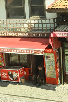 A street view of a traditional Turkish shop with Algida signage, capturing daily life.