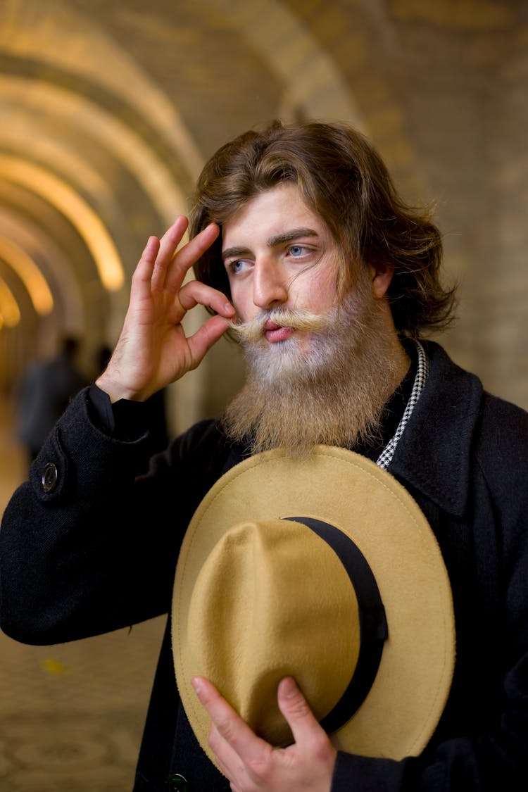 A Man With A Beard And Mustache Holding A Cat 