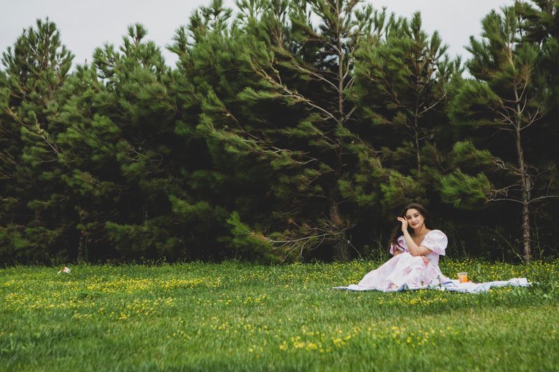 A person relaxing on a picnic blanket in a lush green meadow — photo by Munis Asadov on Pexels